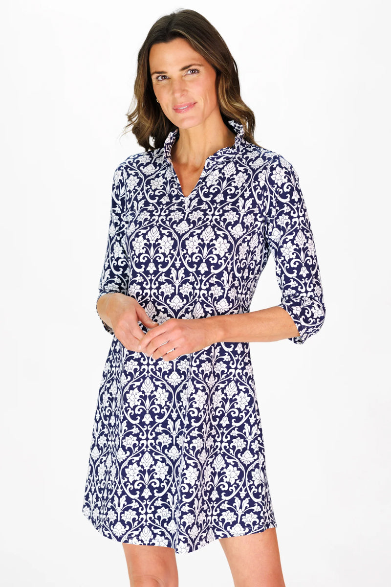 Woman wearing a navy and white patterned dress on a white background