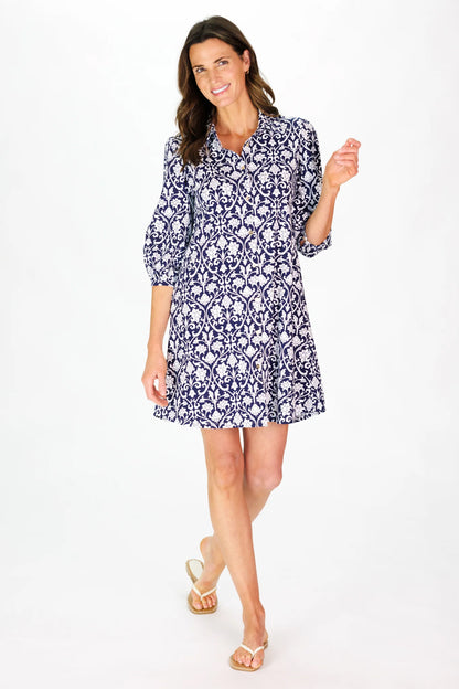 Woman wearing a blue and white patterned dress on a white background