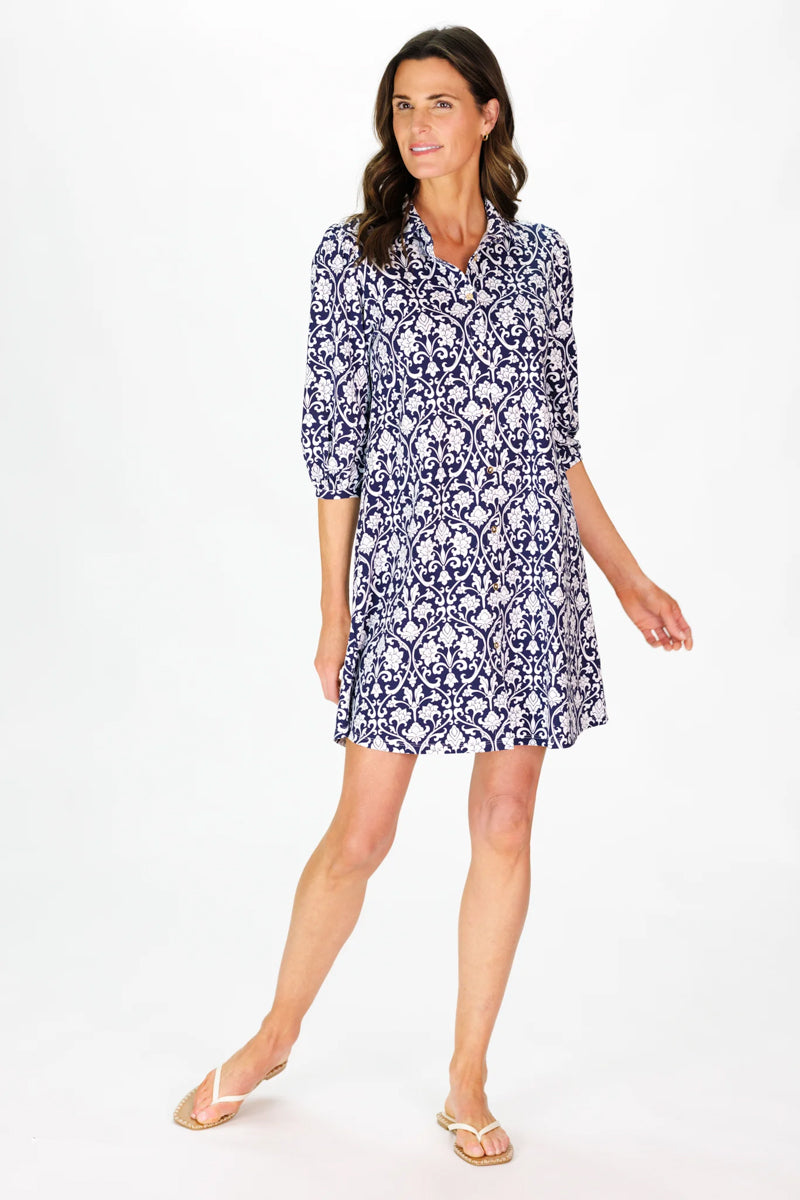 Woman wearing a blue patterned dress on a white background