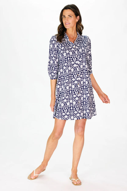 Woman wearing a blue patterned dress on a white background