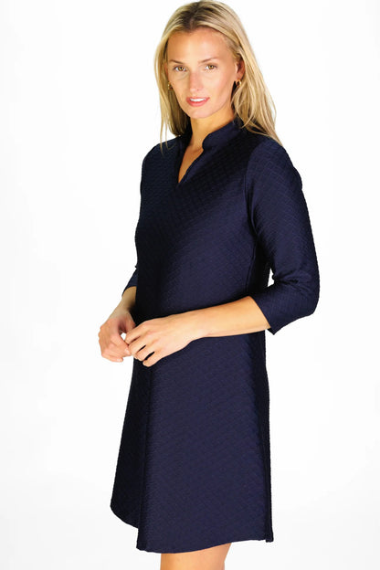 Woman wearing a navy blue dress on a white background