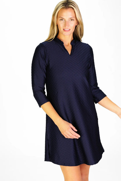 Woman wearing a navy blue dress on a white background