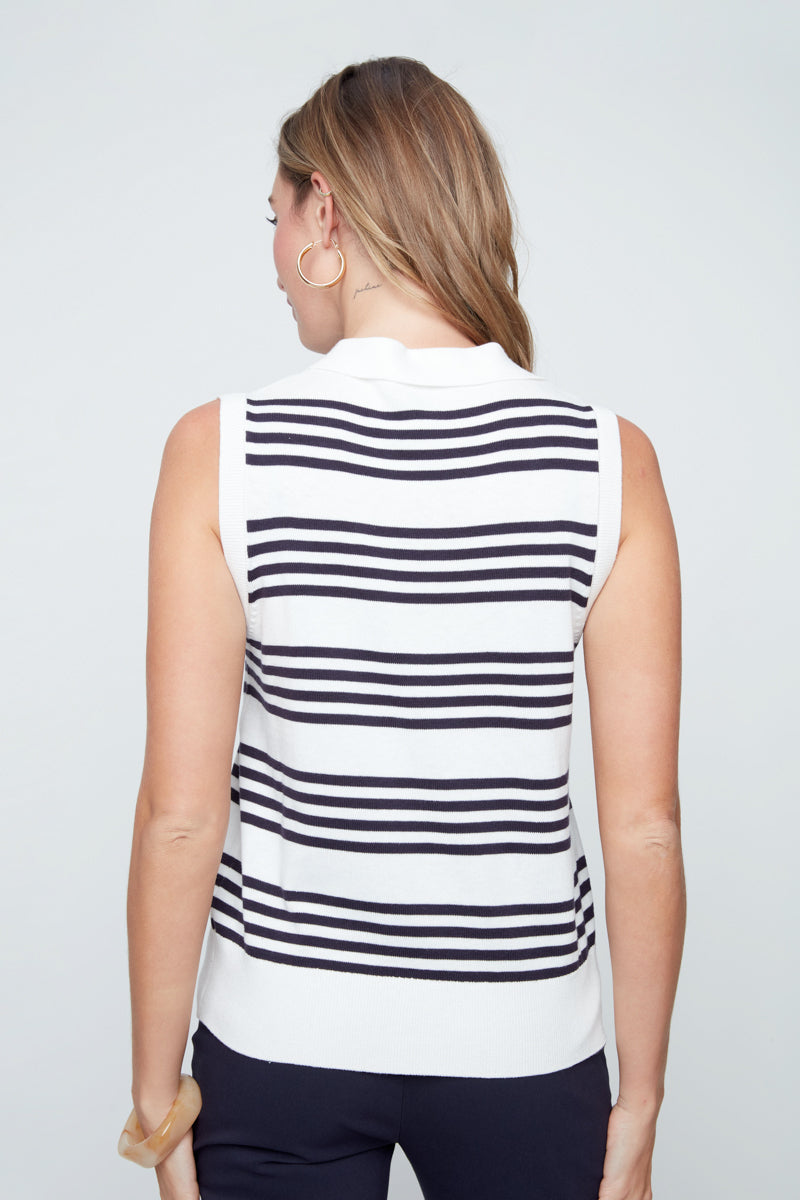 Woman wearing a sleeveless striped shirt against a plain background