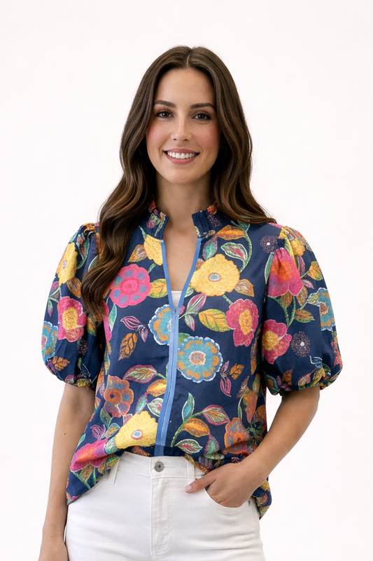 Woman wearing a colorful floral-patterned jacket on a white background