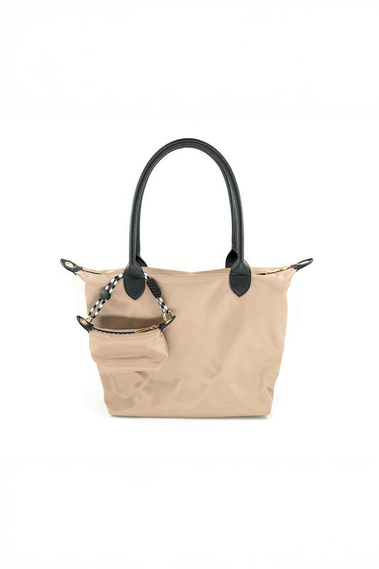 Beige handbag with black handles and trim on a white background
