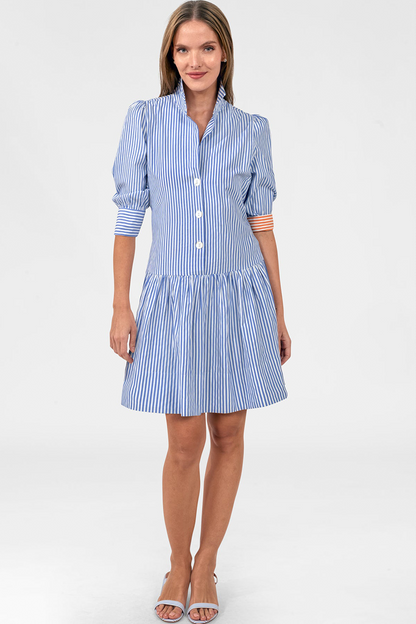 Woman wearing a blue and white striped dress on a white background