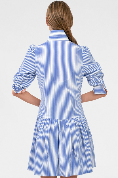 Woman wearing a blue and white striped dress on a white background