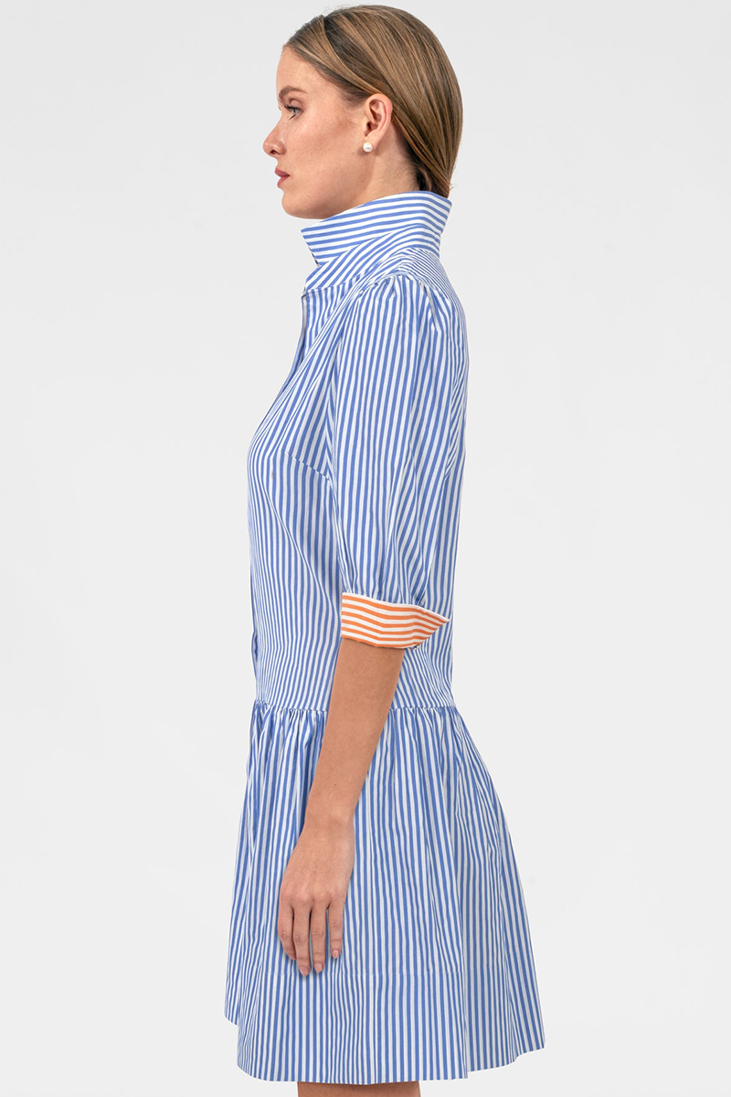 Woman wearing a blue and white striped dress on a white background