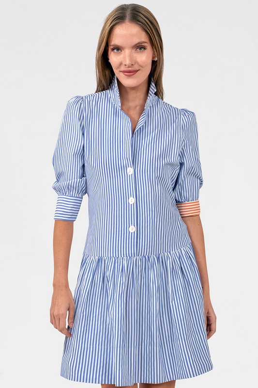 Woman wearing a blue and white striped dress on a light gray background