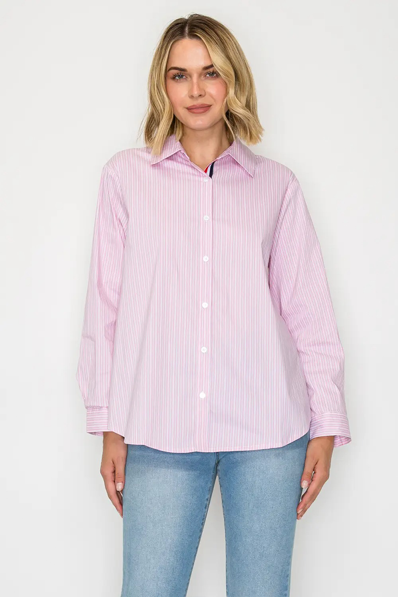 Woman wearing a pink striped shirt and light blue jeans on a white background
