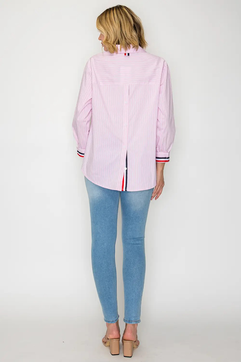 Person wearing a light pink striped shirt and blue jeans on a white background