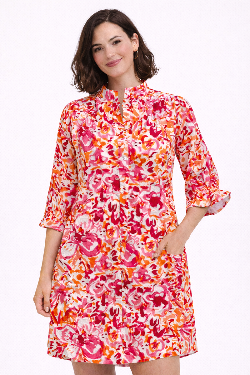 Woman wearing a pink colorful floral dress on a white background