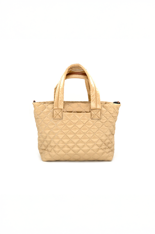 Beige/gold quilted handbag on a white background