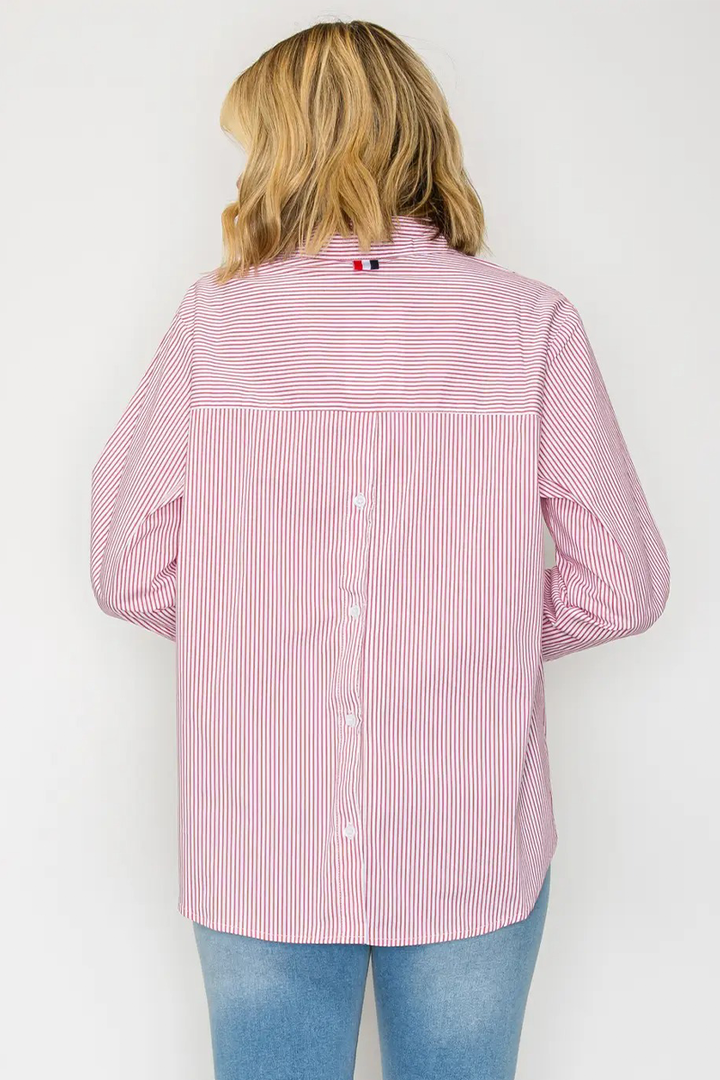 Person wearing a pink and white striped shirt with a visible brand logo on a white background