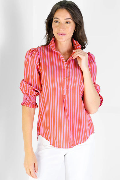 Woman wearing a red and pink striped blouse on a white background