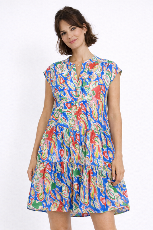 Woman wearing a colorful patterned dress on a white background