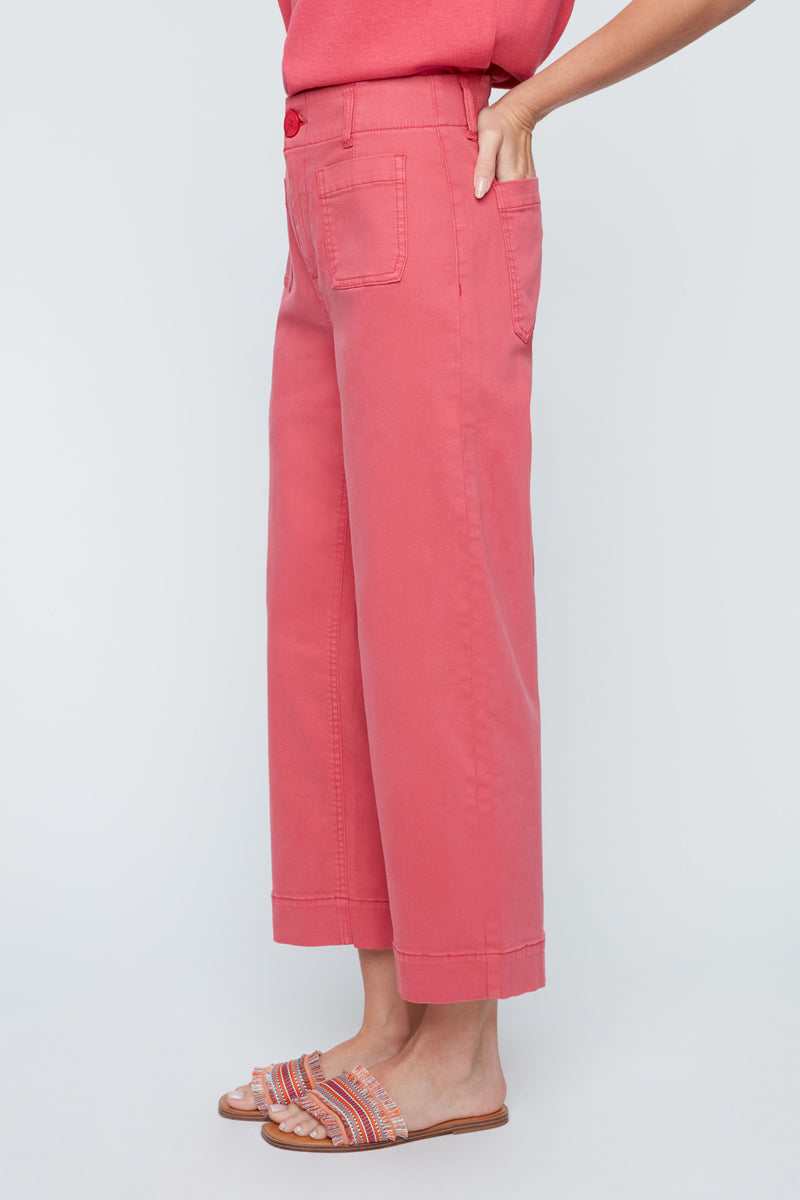 Person wearing pink pants on a light gray background