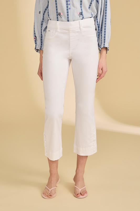 Person wearing white pants and a stripe shirt on a beige background