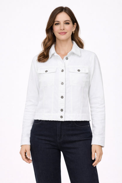 Woman wearing a white denim jacket and dark jeans on a white background
