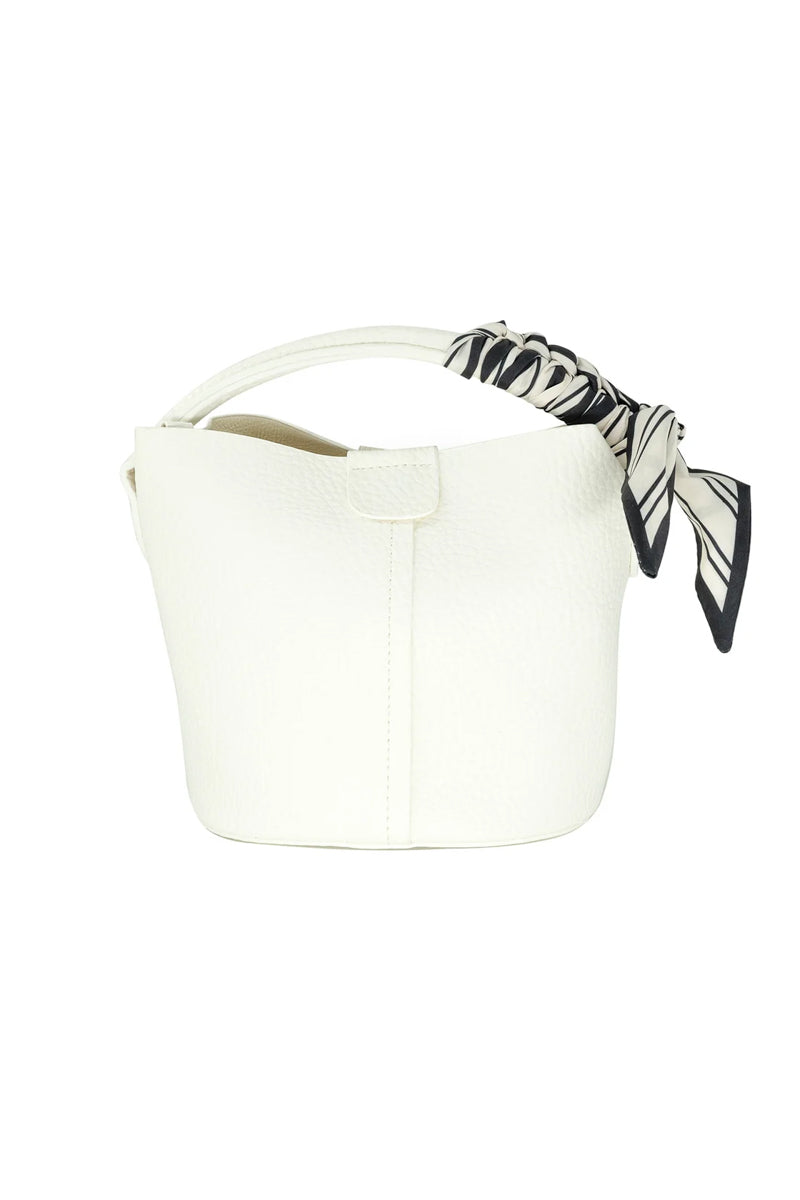 White bucket bag with a black and white striped handle on a white background