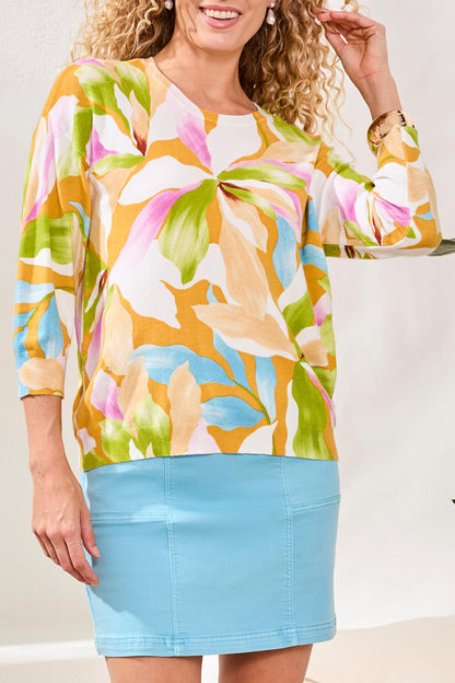 Woman wearing a colorful floral blouse and blue skirt on a white background