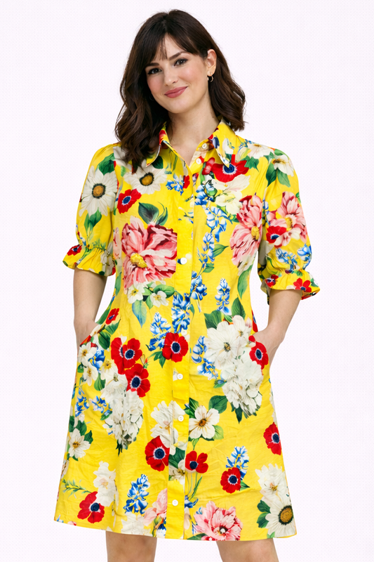Woman wearing a yellow floral dress on a white background